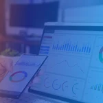 Modern data analytics workspace with dashboards on a laptop and smartphone, displaying charts and KPIs under a blue-orange gradient. Represents B EYE’s Data Maturity Assessment and AI-readiness evaluation.